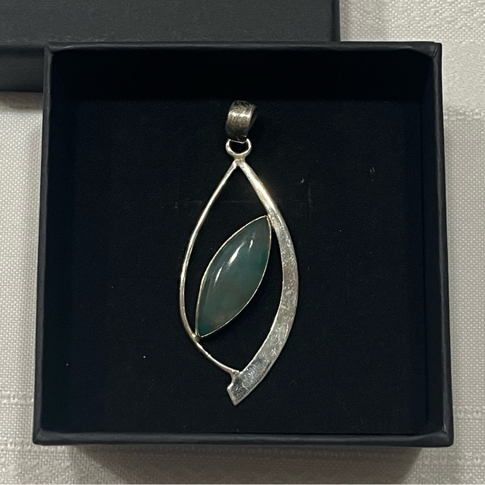 Sterling silver pendant. Green stone. Unique leaf like design. Simple. Classy